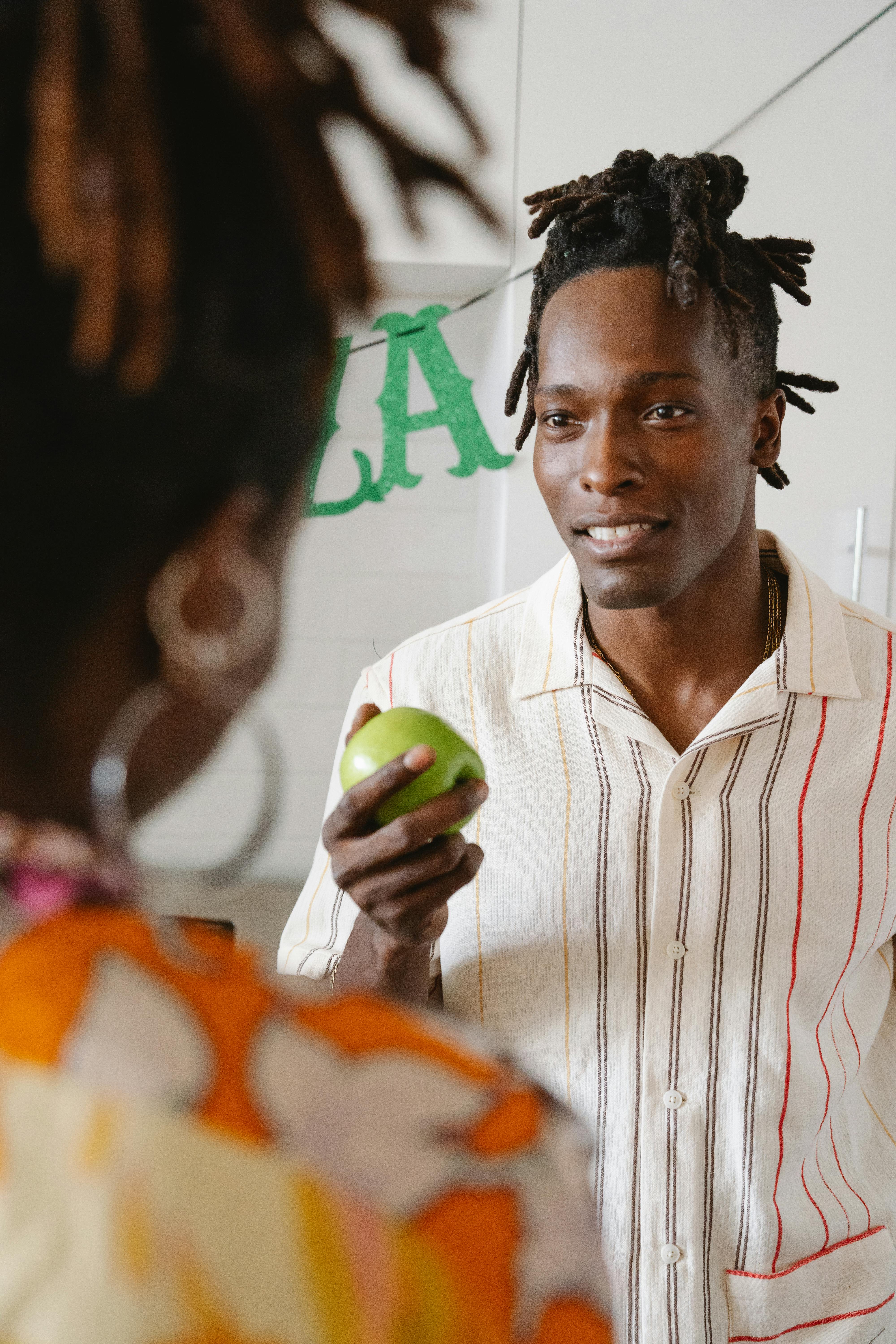 Man Holding a Green Apple · Free Stock Photo