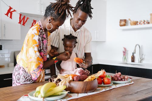 Mom and Dad Feeding Their Daughter