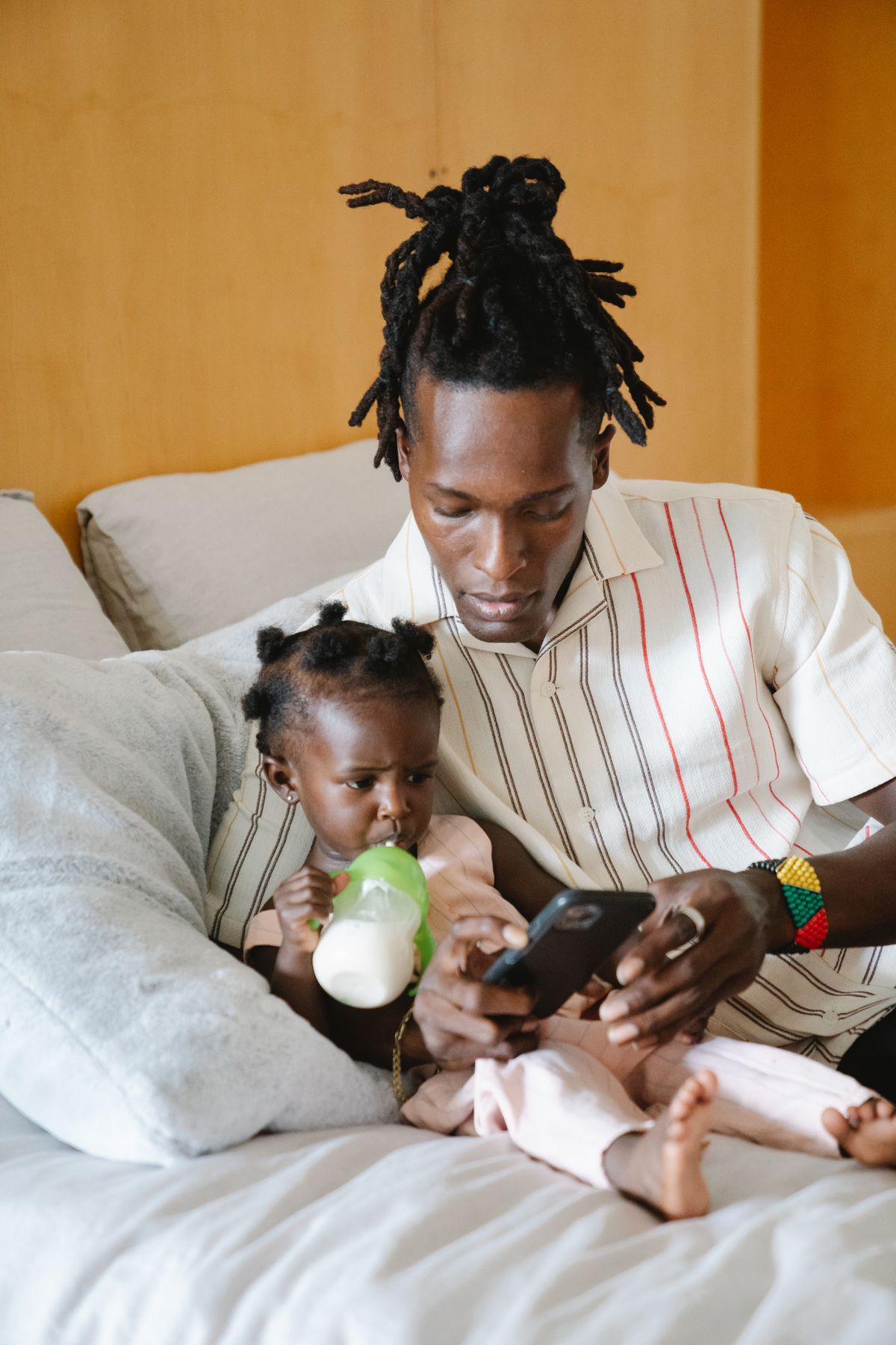 A parent and child looking at photos together on a smartphone