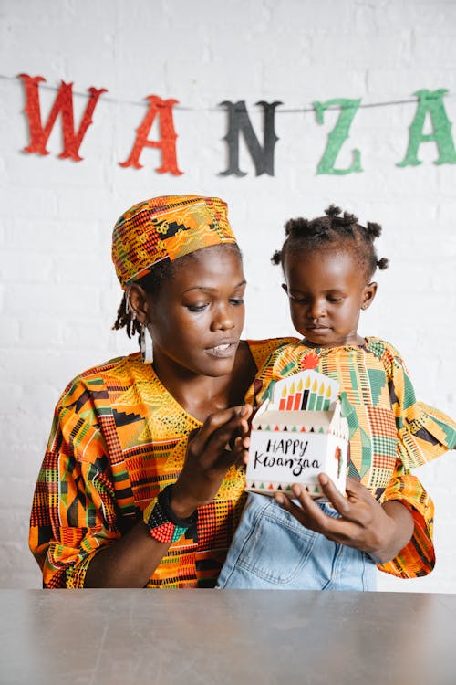 Free Mom and Daughter in Traditional Clothes Celebrating Kwanzaa Together Stock Photo