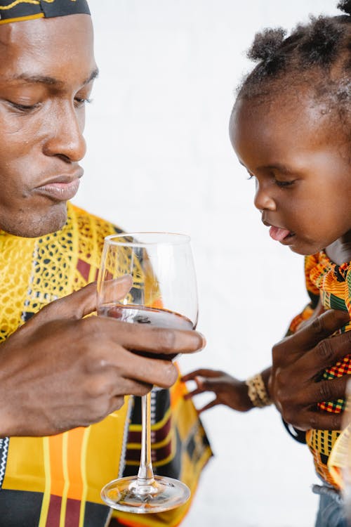 Free Dad Holding a Glass of Red Wine Stock Photo