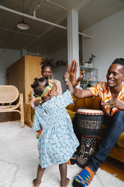 Free A happy family enjoying a playful moment indoors with traditional elements. Stock Photo