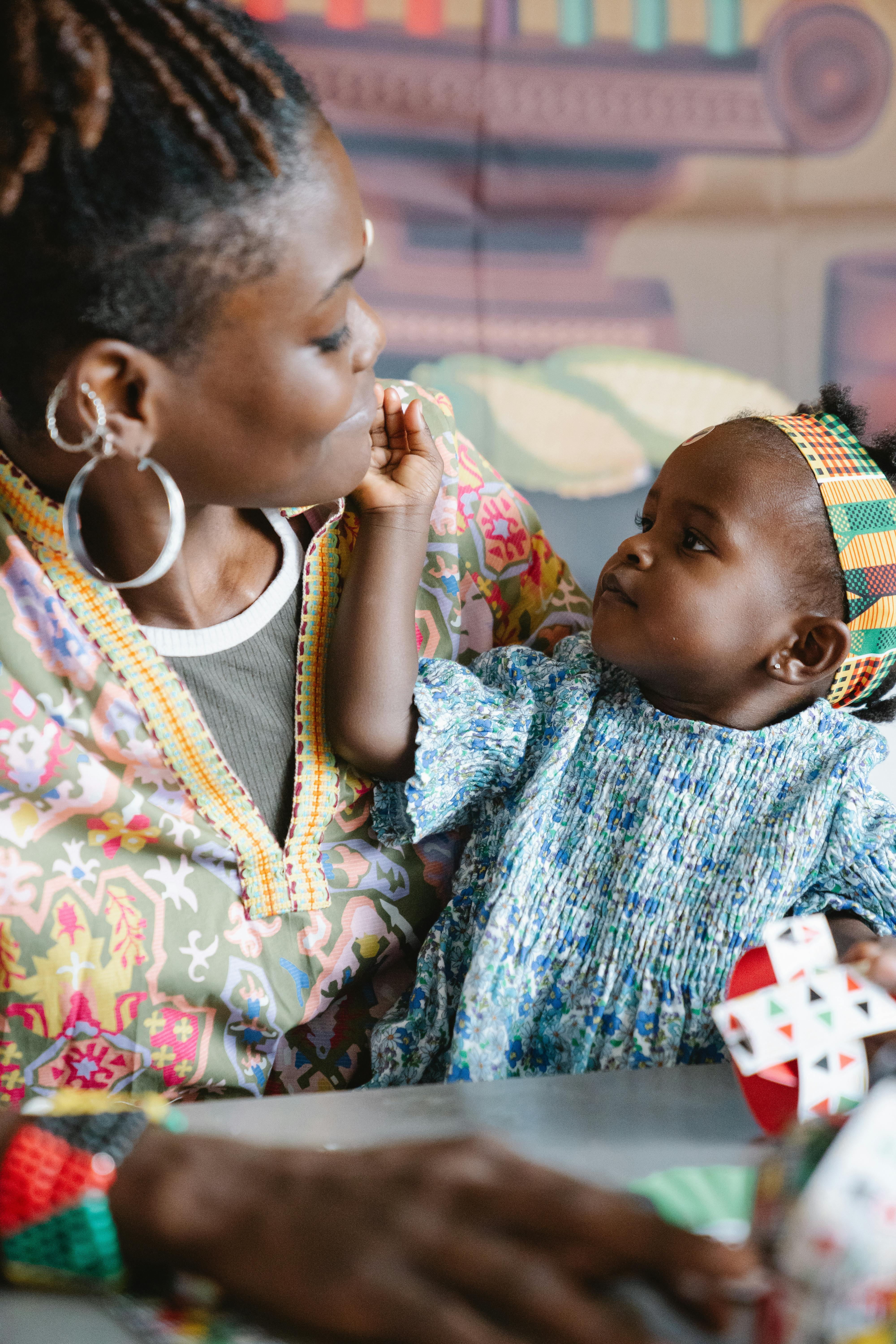 A touching moment between a mother and her daughter sharing love at home.