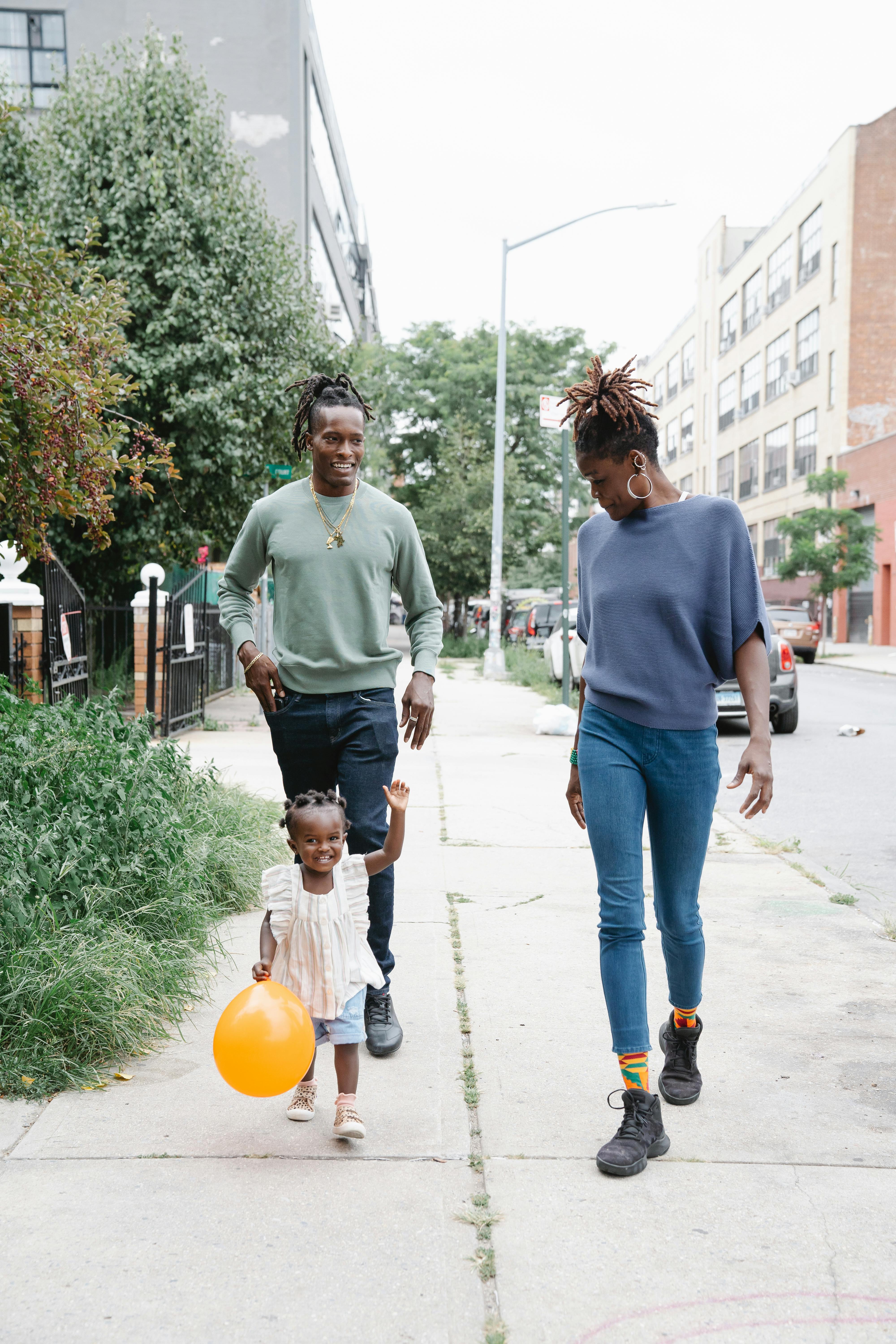 a family walking at the sidewalk