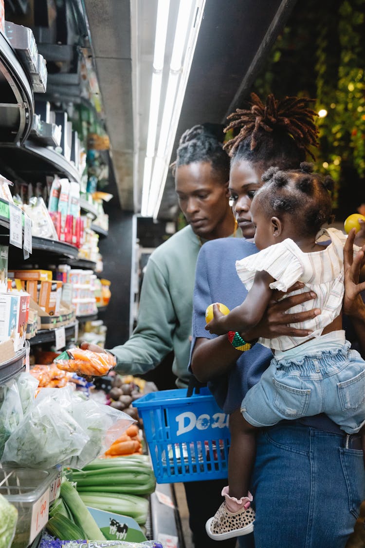 A Family Buying Groceries In A Supermarket