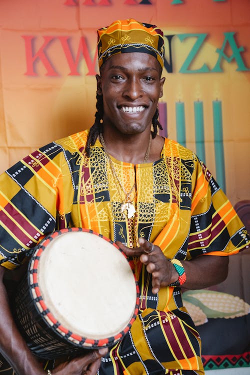 A Man Holding a Percussion Instrument