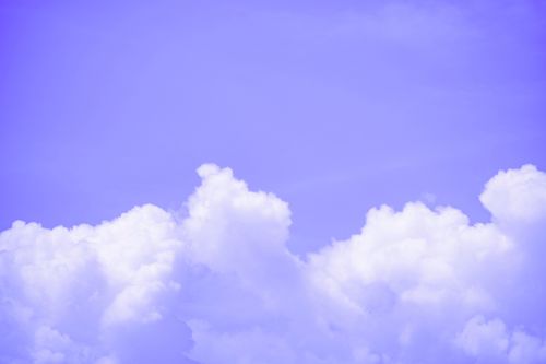 Free Serene purple sky showcasing soft, fluffy clouds in a tranquil setting, perfect for backgrounds or wallpapers. Stock Photo