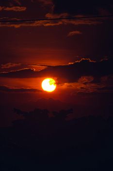 A stunning sunset with dramatic clouds and rich orange tones perfect for serene and contemplative settings.
