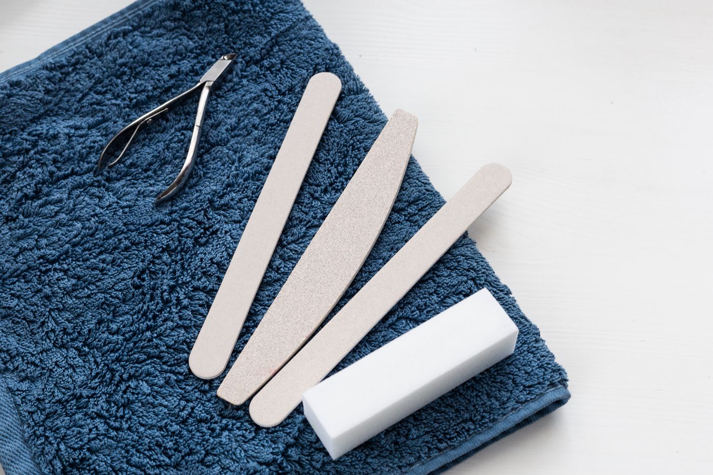 Clean manicure instruments arranged neatly on a fresh towel