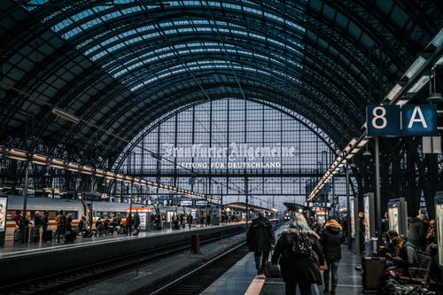 Free Interior view of Frankfurt Hauptbahnhof with trains and commuters. Stock Photo