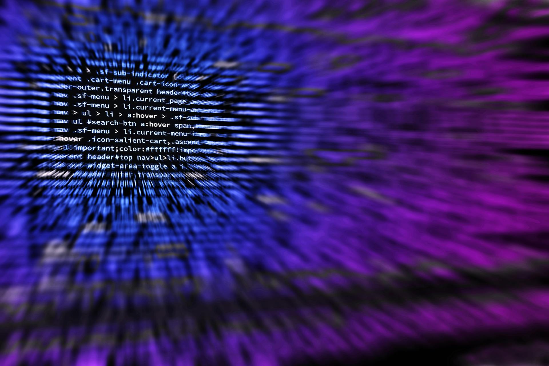 Dynamic abstract background featuring computer code in focus with blurred effect.