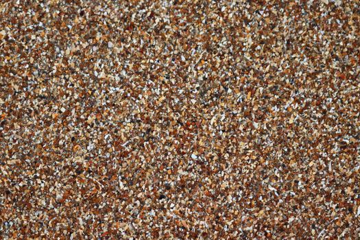 Detailed image of a textured surface made of crushed seashells, perfect for backgrounds or wallpapers.