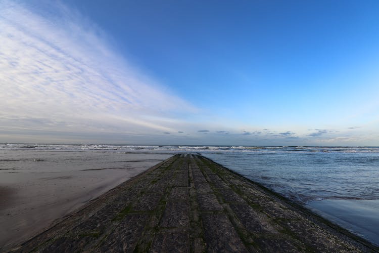 Blue Sky Over Concrete Jetty