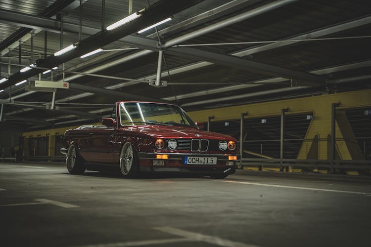 A Red Convertible Car Parked Inside The Garage