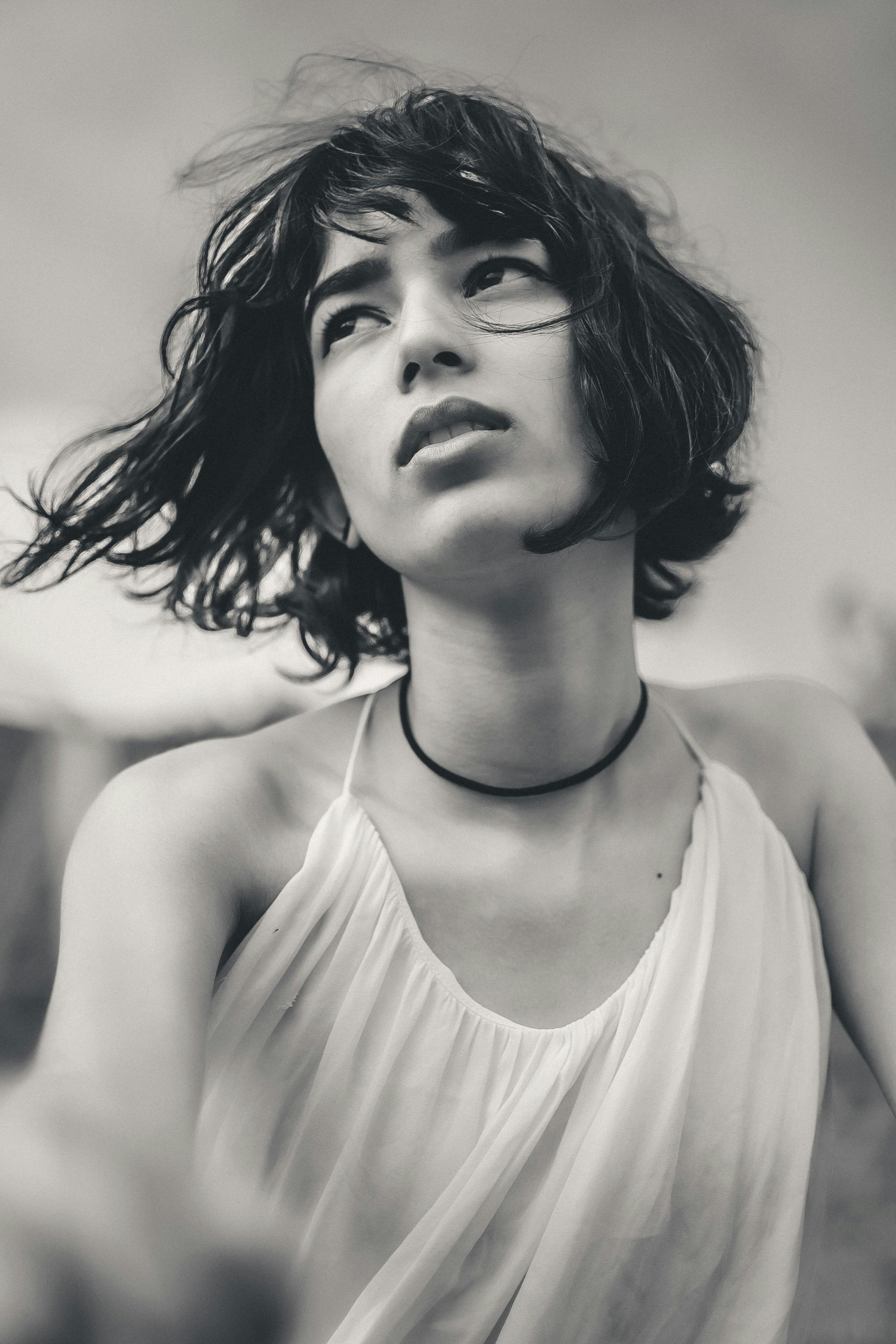 Striking black and white portrait of a woman with short hair and a thoughtful expression.