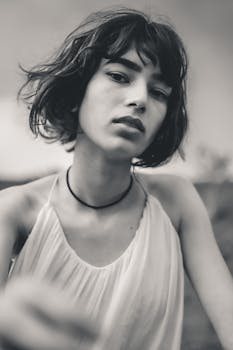 Stylish grayscale portrait capturing a young woman in a tank top.