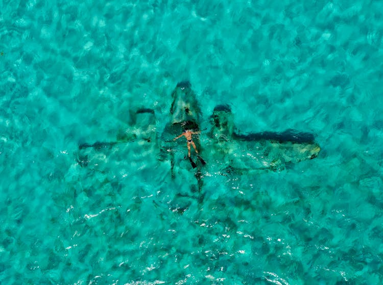 Man Floating Above A Plane Wreck