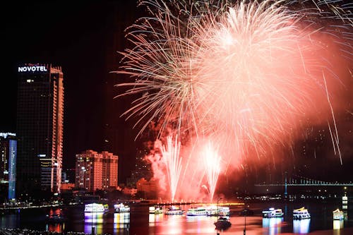 Fireworks Display over City Buildings during Night Time