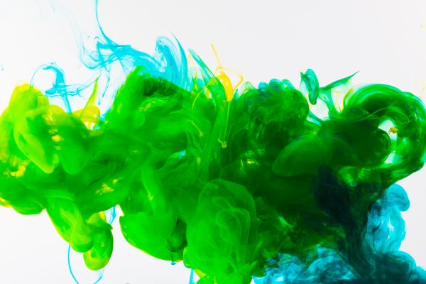 Green and blue ink blooming in water — photo by Engin Akyurt on Pexels