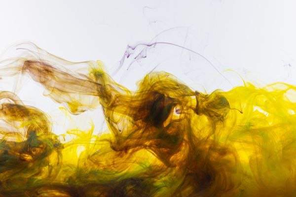 Yellow and brown ink swirling in water — photo by Engin Akyurt on Pexels