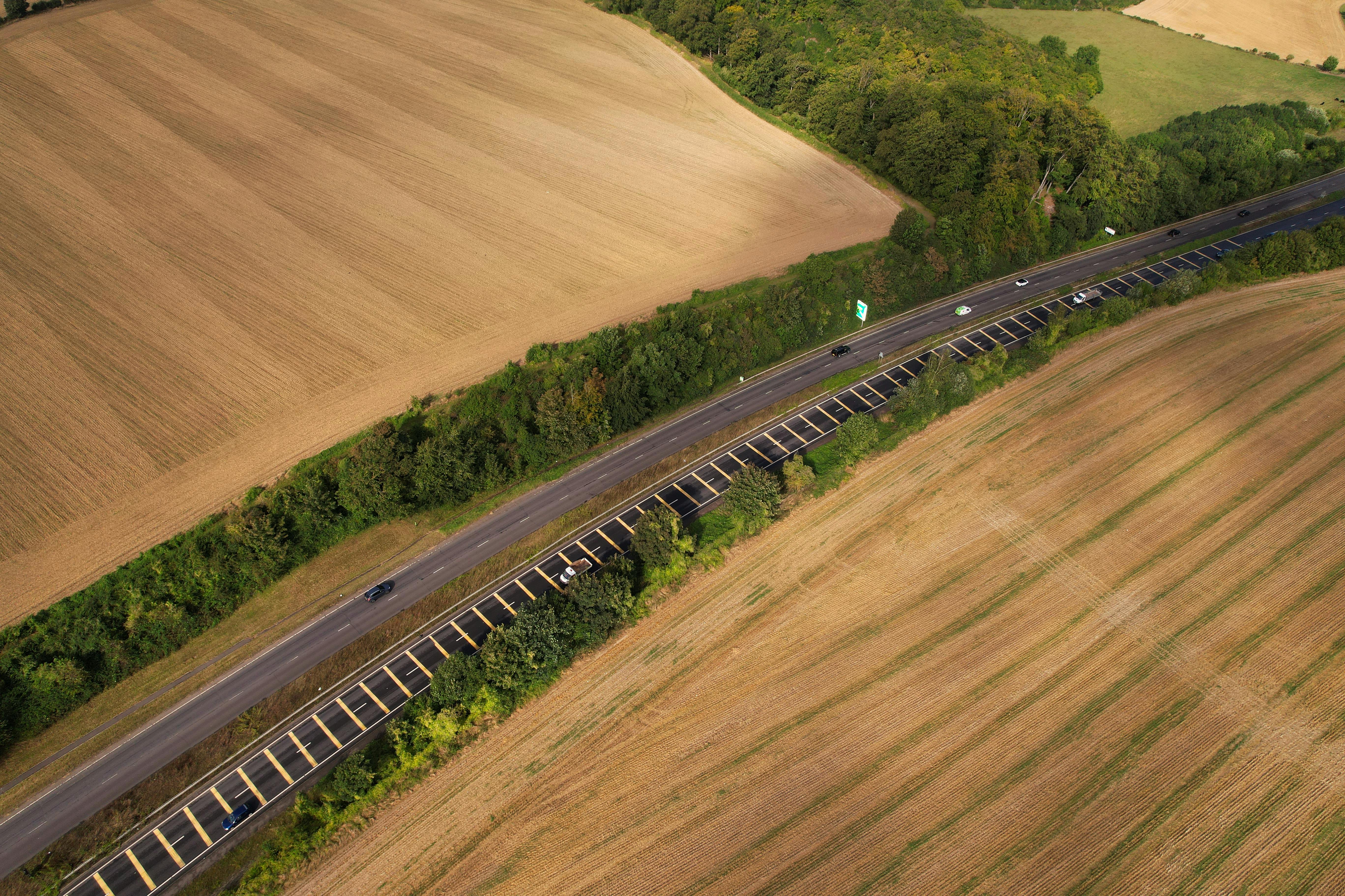Aerial view of a highway surrounded by fields in Central Bedfordshire, England.