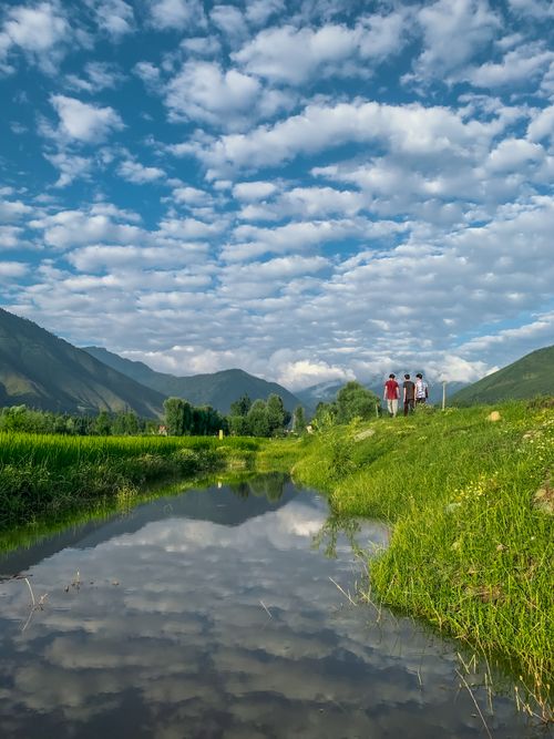Free Beautiful countryside view with reflection in water, puffy clouds in the sky. Stock Photo