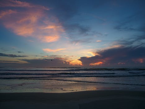 A tranquil ocean sunrise, capturing vivid colors and serene waves, perfect for peaceful seascape themes.