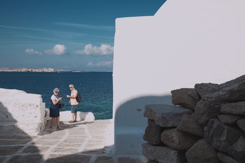 Two People Next To Ocean