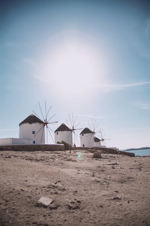 Four Windmills Near Body Of Water