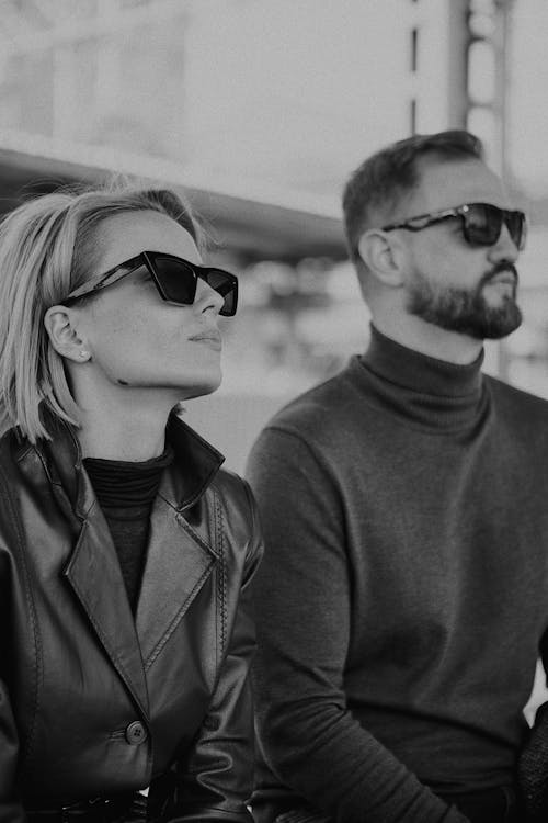 Grayscale Photo of a Man and a Woman Wearing Sunglasses