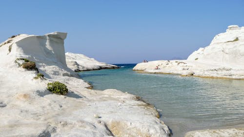 White Rock Formation Near Blue Sea Under Blue Sky