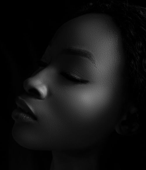 Free Stunning black and white portrait highlighting a woman's elegant profile in soft light. Stock Photo