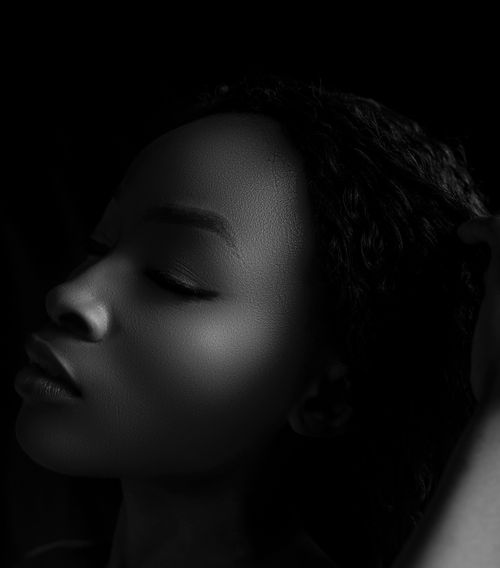 Free Artistic black and white close-up portrait of a woman's side profile with eyes closed. Stock Photo
