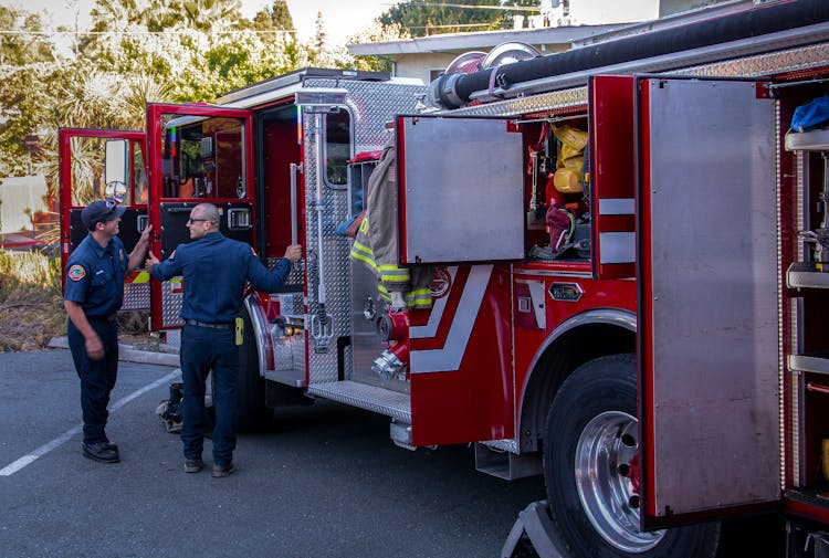 Men Inspecting Fire Trucks