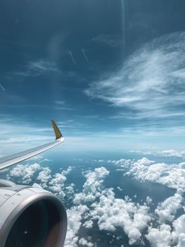A stunning aerial view from an airplane wing over the clouds above Western Visayas, Philippines.