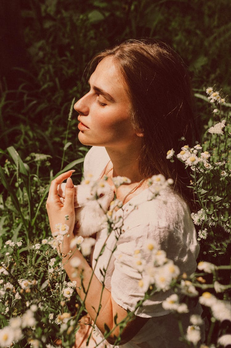 Young Woman Posing On Meadow With Daisies