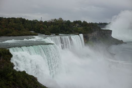 Breathtaking view of Niagara Falls with cascading waters and lush greenery.