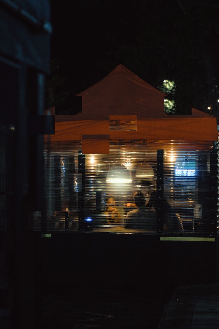 Illuminated Bar Interior Seen From A Window By Night