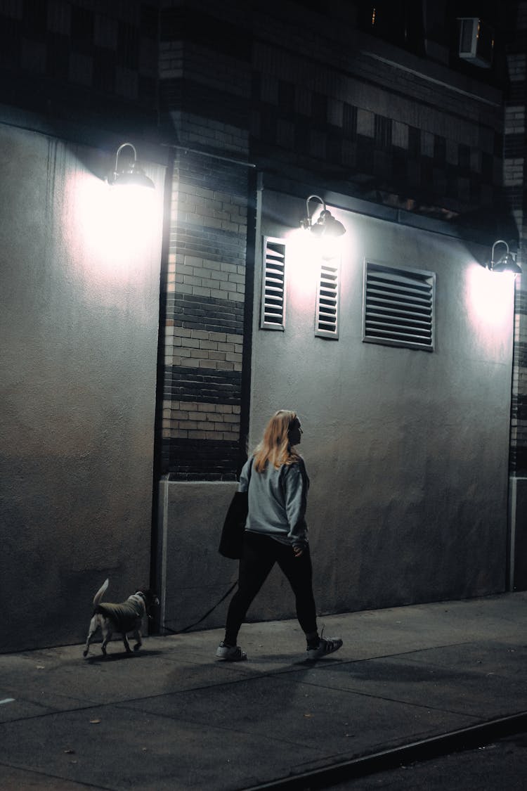 Blonde Woman Walking With Her Dog 