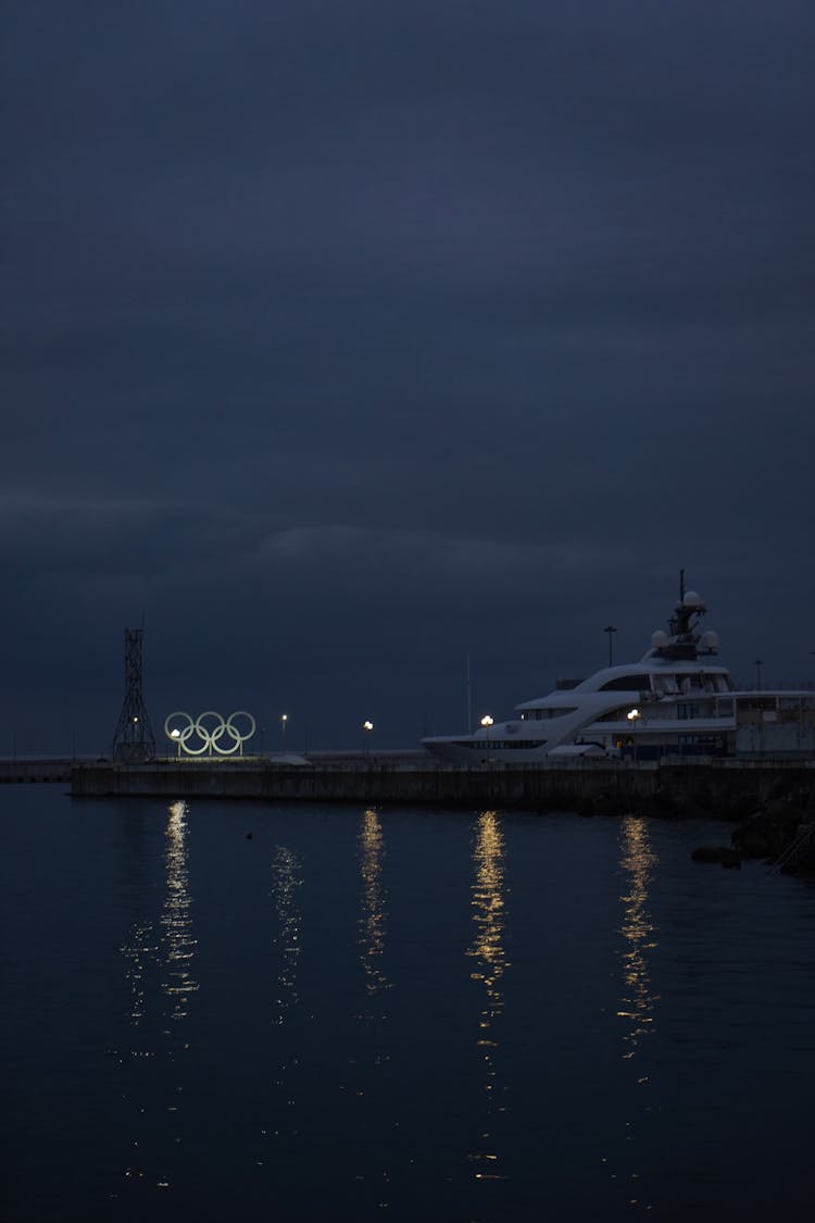 Cruise Ship And Olympics Rings On The Sea At Dusk 