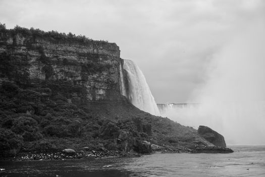 Stunning grayscale capture of Niagara Falls in New York, showcasing the powerful cascading water.