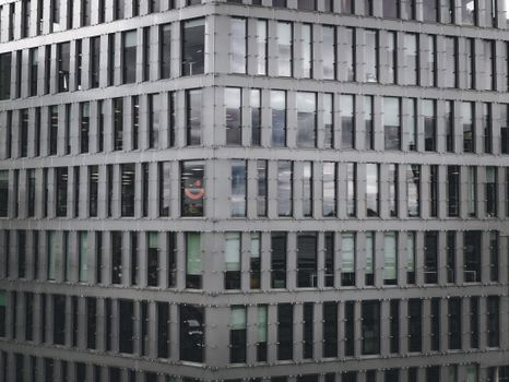 Exterior view of a modern highrise building with a pattern of glass windows.