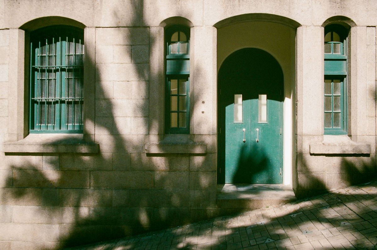 A weathered green front door set in a stone wall - Let the Redeemed Say So