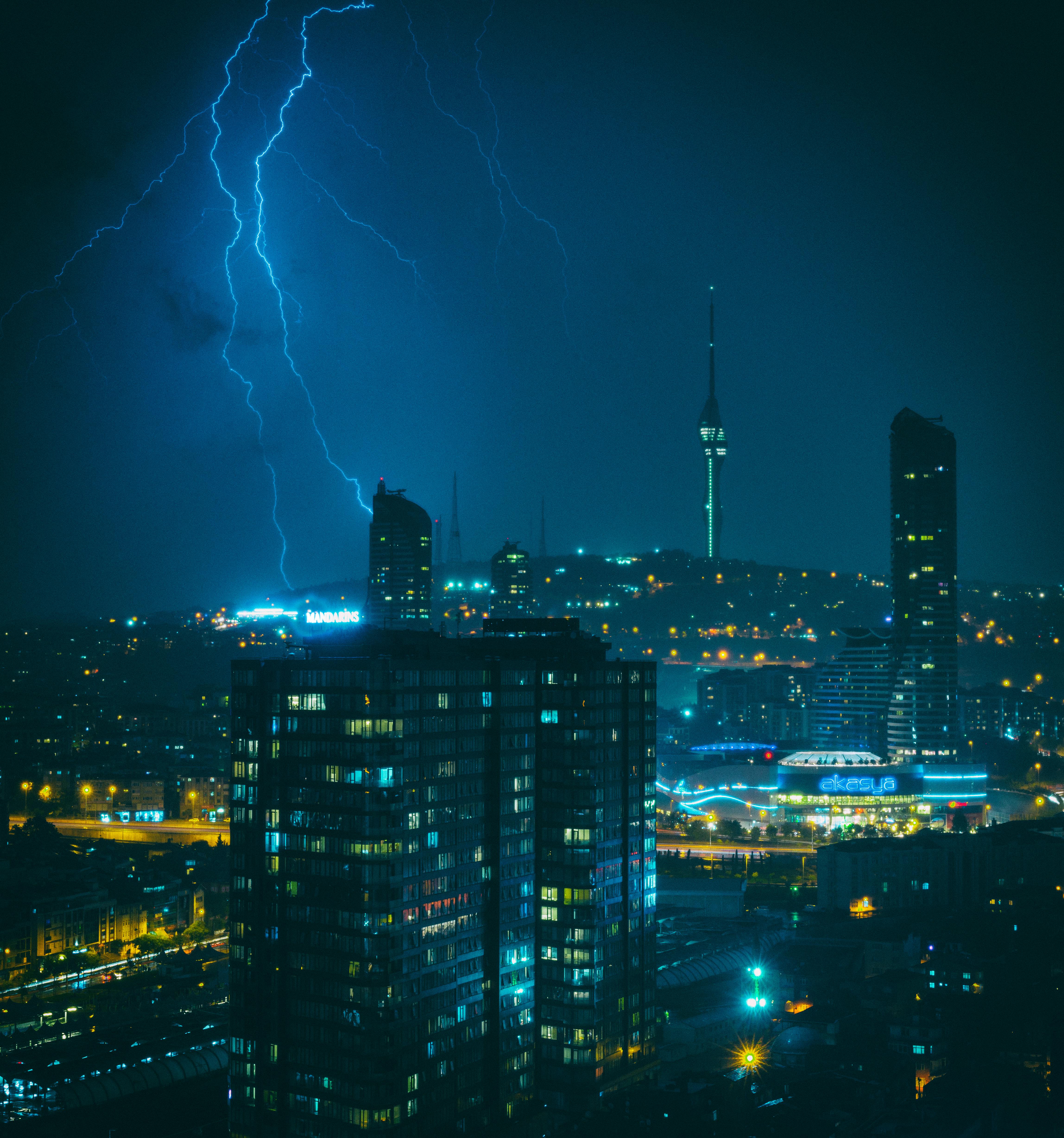 A powerful lightning strike illuminates the Istanbul cityscape at night, showcasing the iconic skyline.