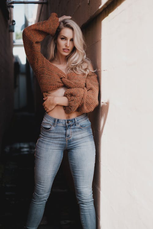 Beautiful Woman Posing in Brown Cropped Knit Sweater and Denim Pants