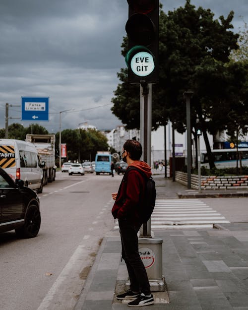 A Man Standing on the Sidewalk