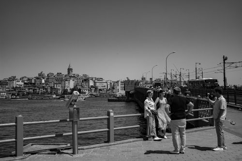 Free Black and white photo of tourists on Galata Bridge, Istanbul with city view. Stock Photo
