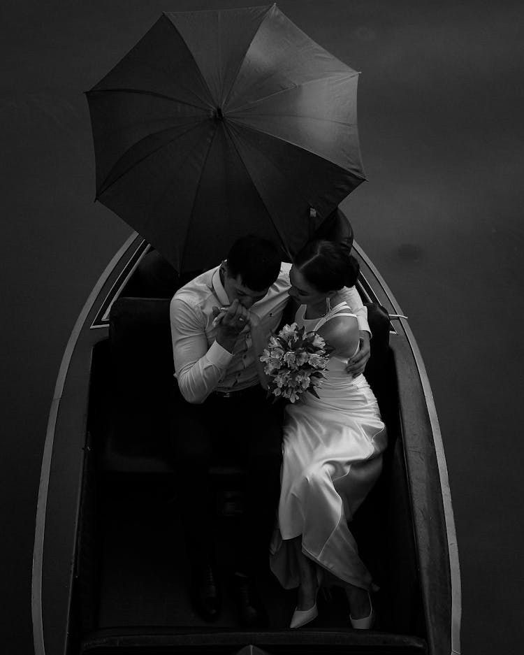 MAn Kissing Womans Hand In Boat