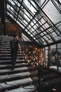 Woman in Black Long Sleeve Shirt Standing on Staircase
