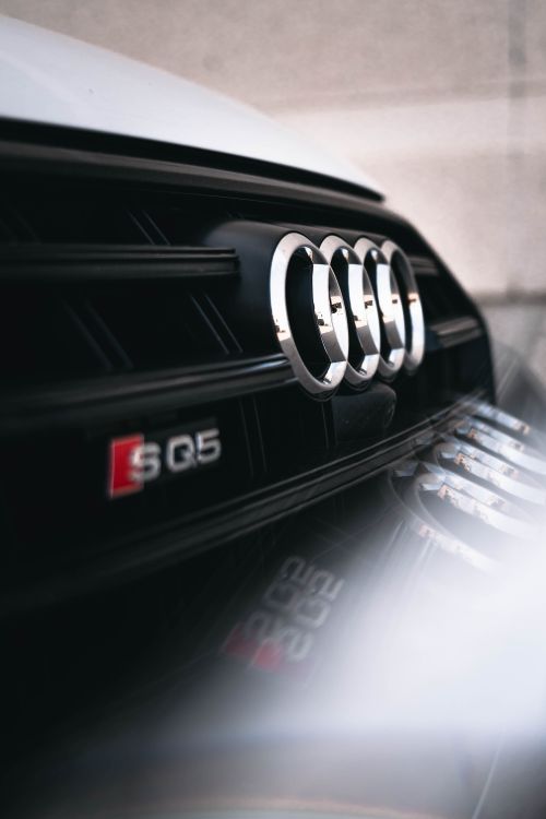 Free Detailed close-up of the Audi SQ5 emblem highlighting the vehicle's sleek design. Stock Photo
